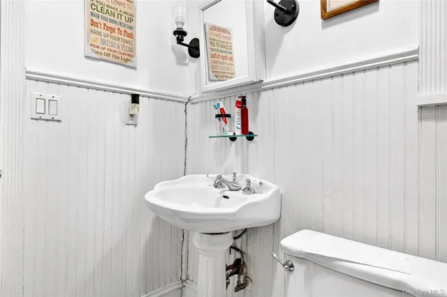 a bathroom with a sink a toilet and shower curtain