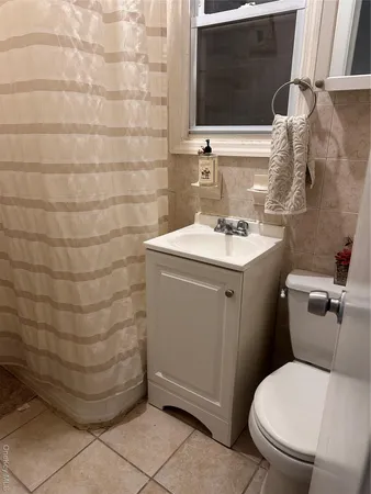a bathroom with a sink toilet and mirror