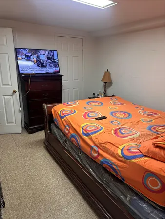 a bedroom with a bed and a dresser