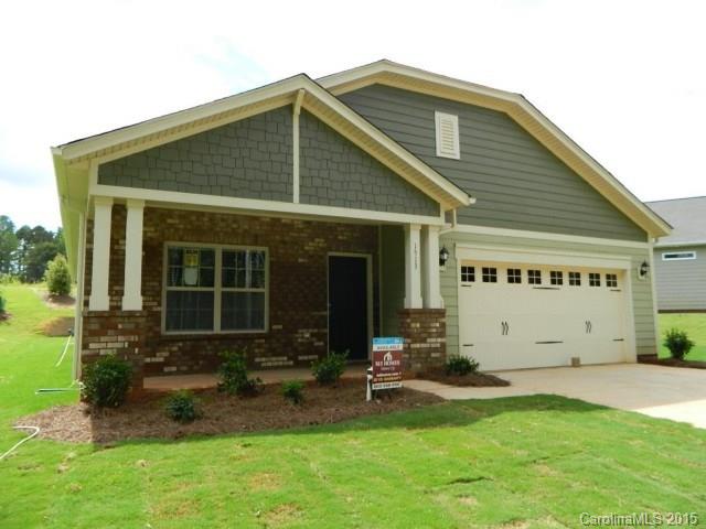 1513 Spring Blossom Trail, Unit SITE 47 Fort Mill, SC 29708 - Photo 1 of 11 a front view of a house with a yard and outdoor seating
