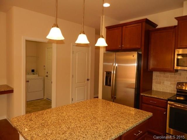 1513 Spring Blossom Trail, Unit SITE 47 Fort Mill, SC 29708 - Photo 2 of 11 a kitchen with stainless steel appliances granite countertop a refrigerator and a stove top oven