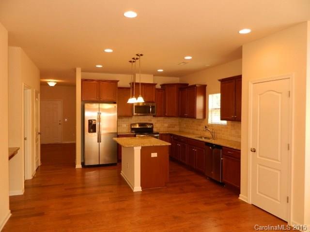 1513 Spring Blossom Trail, Unit SITE 47 Fort Mill, SC 29708 - Photo 4 of 11 a kitchen with stainless steel appliances granite countertop a refrigerator a sink dishwasher and a stove