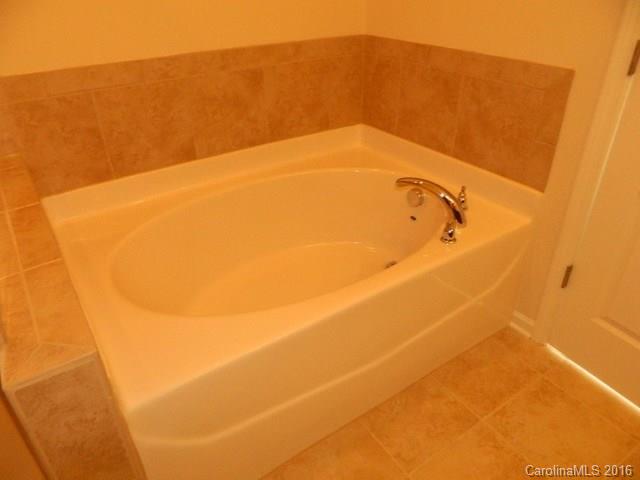 1513 Spring Blossom Trail, Unit SITE 47 Fort Mill, SC 29708 - Photo 9 of 11 a bathroom with a bathtub