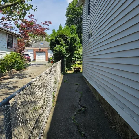 a view of a pathway both side of house