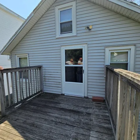 a view of a house with wooden deck