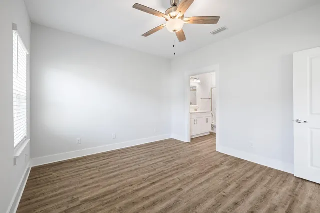 a bathroom with a granite countertop sink a toilet and shower
