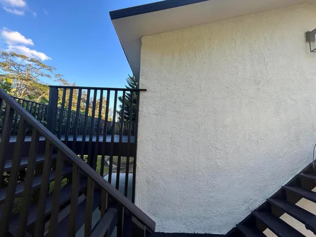 a view of balcony with wooden floor and fence