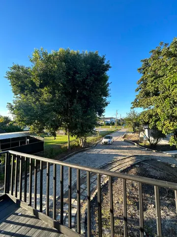 a view of a balcony with a yard
