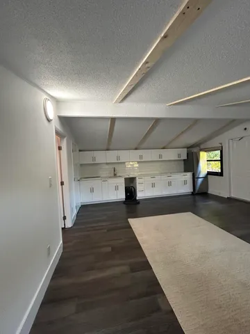 a white kitchen with a stove top oven
