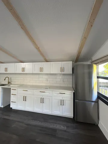 a kitchen with appliances cabinets and a counter top space