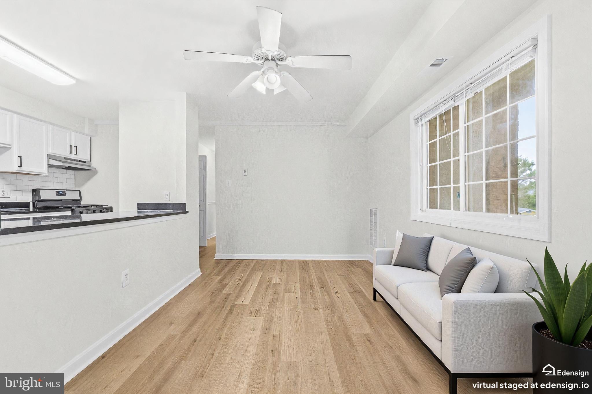 635 Waterloo Road, Unit 222 Warrenton, VA 20186 - Photo 10 of 28 a living room with furniture and a large window