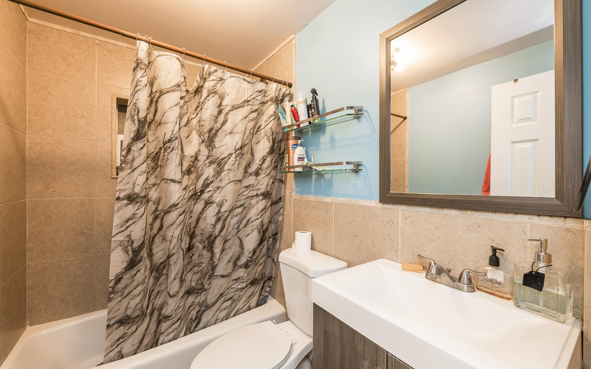 1821 Harris Avenue Key West, FL 33040 - Photo 14 of 27 a bathroom with a sink and a mirror