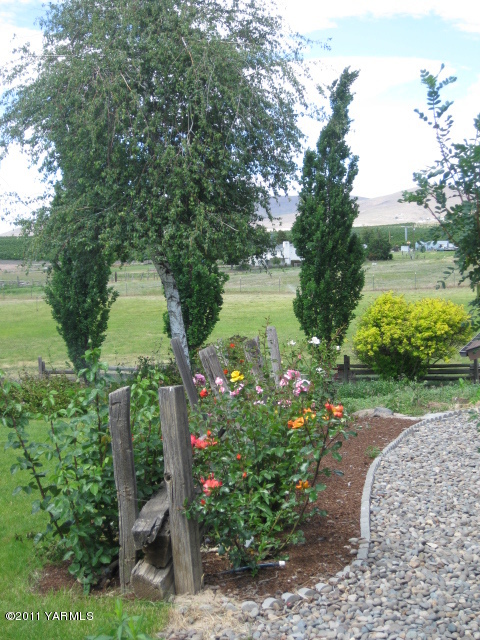 210 White Road Yakima, WA 98901 - Photo 45 of 63 a view of a garden with a lake view