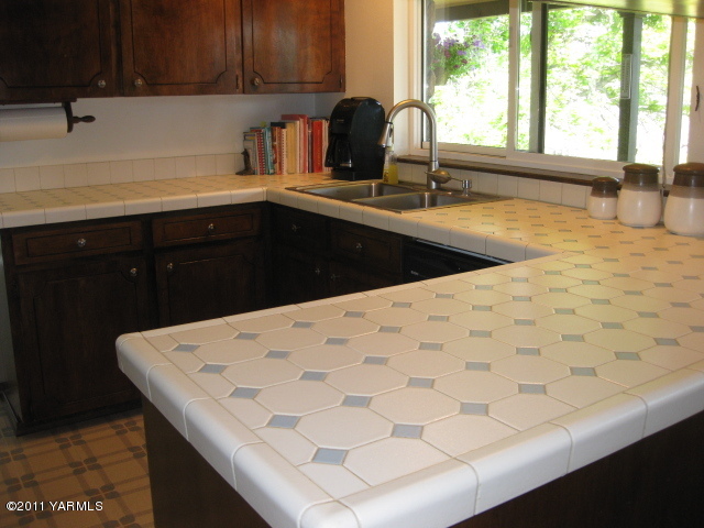210 White Road Yakima, WA 98901 - Photo 10 of 63 a kitchen with a sink a window and cabinets
