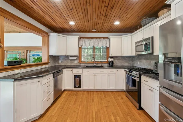 a kitchen with a stove a sink and a refrigerator