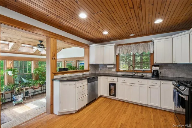 a kitchen with stainless steel appliances granite countertop a stove a sink dishwasher a refrigerator and a microwave oven