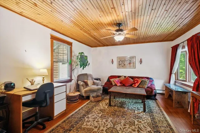 a bathroom with a granite countertop sink a large mirror and a toilet