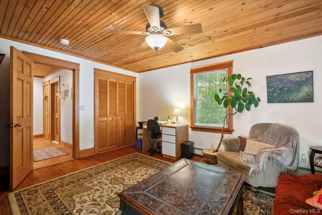 a living room with furniture a rug and a window