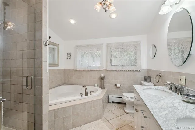 a bathroom with a granite countertop sink mirror and bathtub