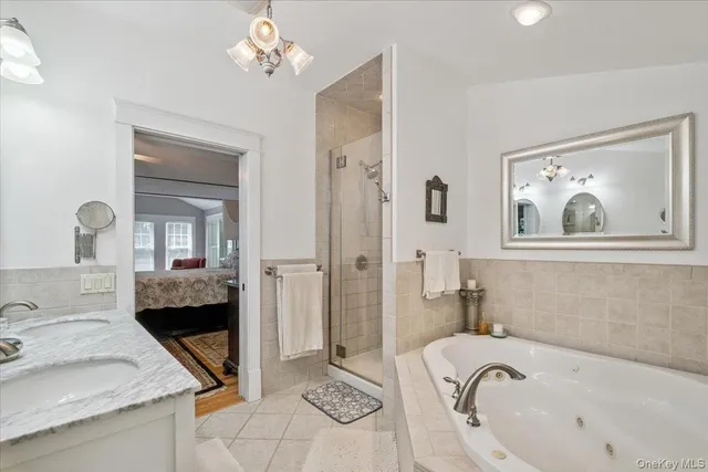 a bathroom with a tub sink and mirror