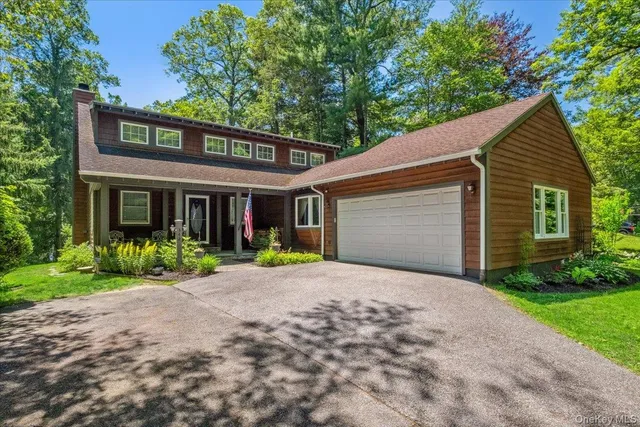a front view of a house with garden and porch
