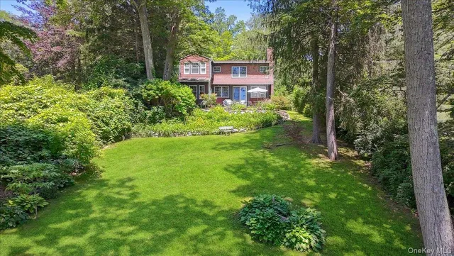 a front view of a house with a yard table and chairs