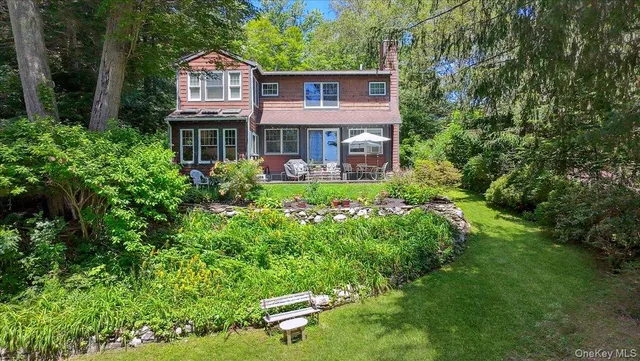 a view of a table and chairs in a backyard