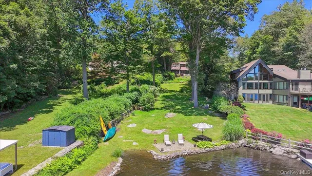 a view of house with garden space and lake view
