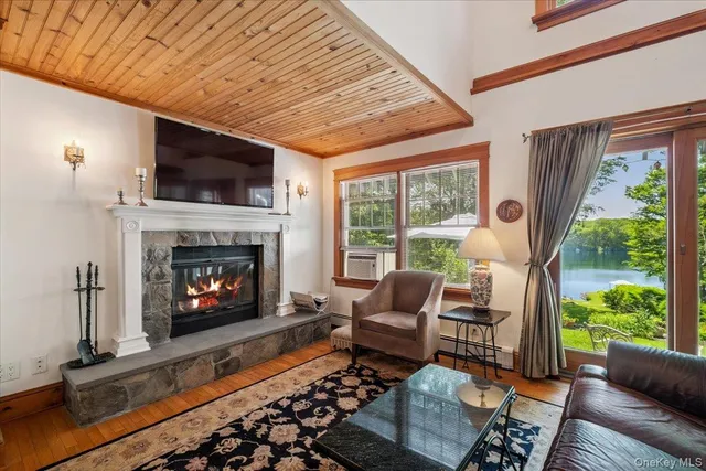 a living room with furniture fireplace and a large window