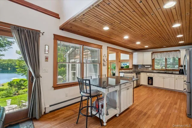 a very nice looking living room with a large window and wooden floor