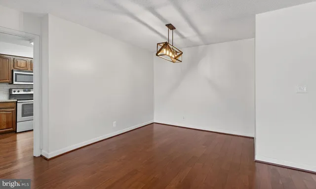 a view of a room with wooden floor