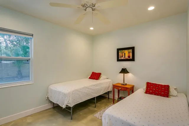 a bedroom with two beds and painted walls