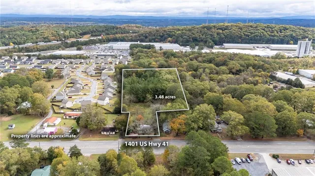 an aerial view of residential houses with outdoor space and swimming pool