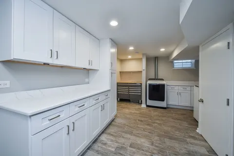 a kitchen with stainless steel appliances kitchen island granite countertop a stove a sink and a refrigerator