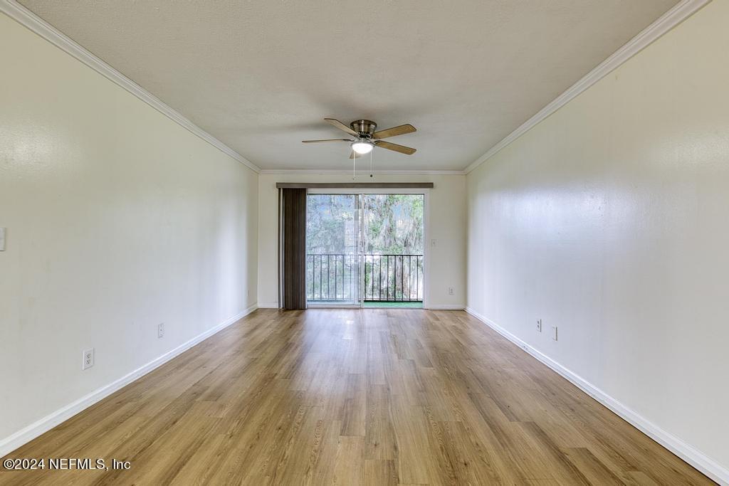 1768 El Camino Road, Unit 7 Jacksonville, FL 32216 - Photo 11 of 43 wooden floor in an empty room with a window