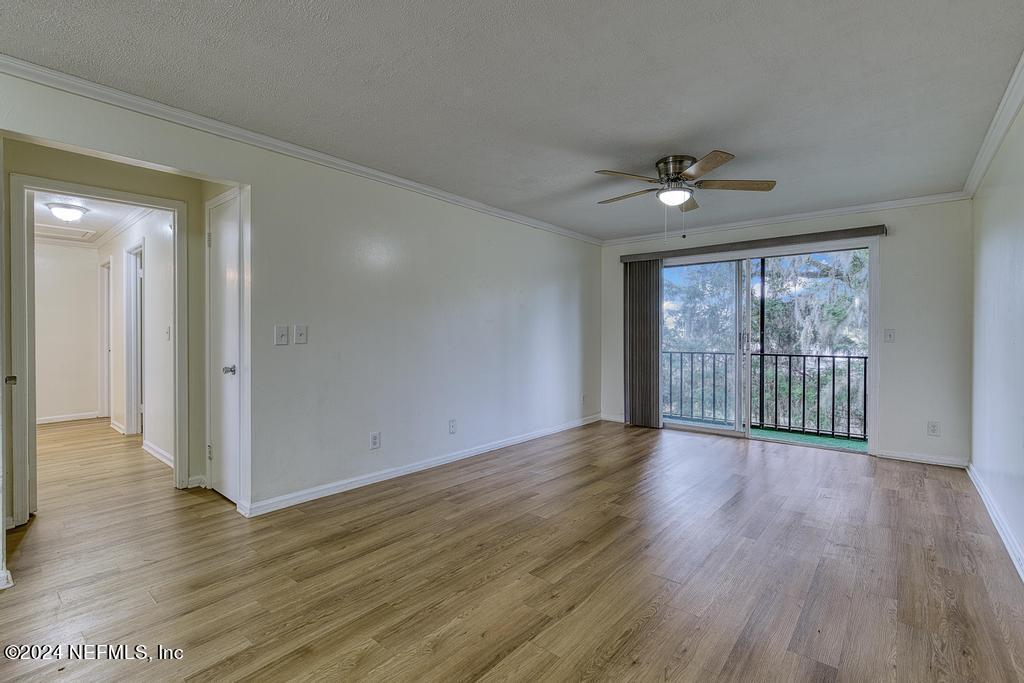 1768 El Camino Road, Unit 7 Jacksonville, FL 32216 - Photo 12 of 43 a view of an empty room with wooden floor and a window