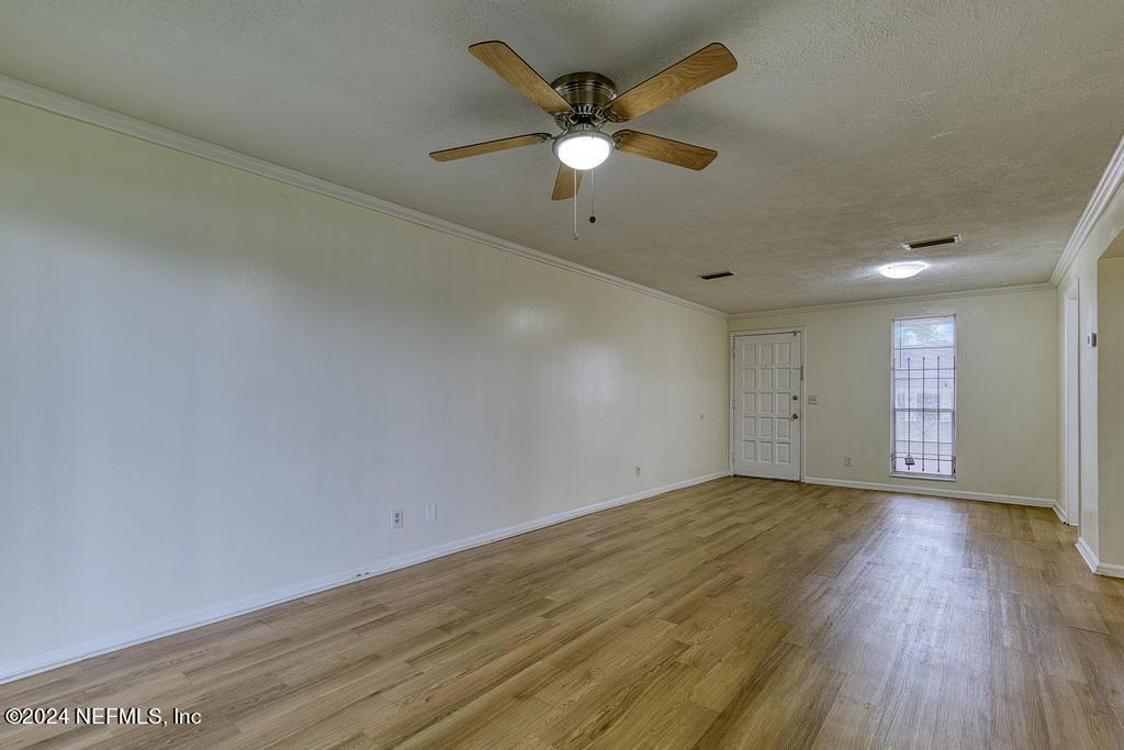 1768 El Camino Road, Unit 7 Jacksonville, FL 32216 - Photo 13 of 43 an empty room with wooden floor and ceiling fan
