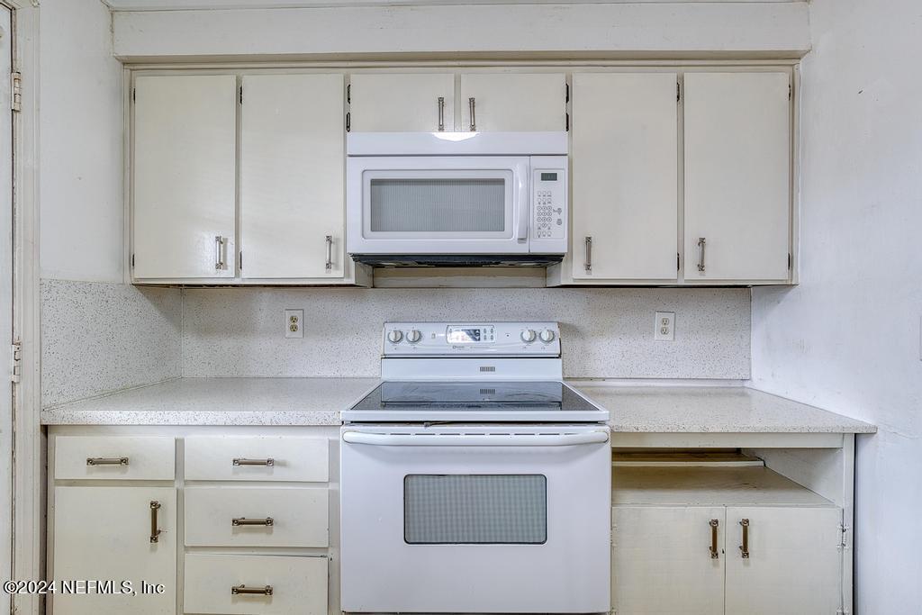 1768 El Camino Road, Unit 7 Jacksonville, FL 32216 - Photo 16 of 43 a stove top oven sitting inside of a kitchen