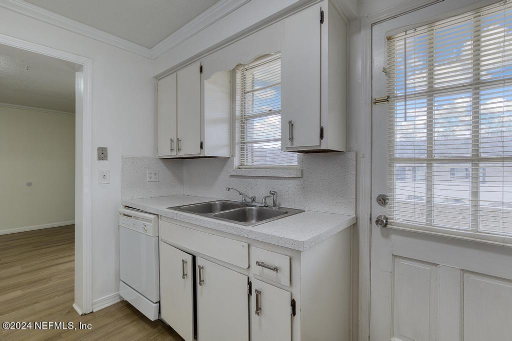 1768 El Camino Road, Unit 7 Jacksonville, FL 32216 - Photo 18 of 43 a kitchen with white cabinets and a window