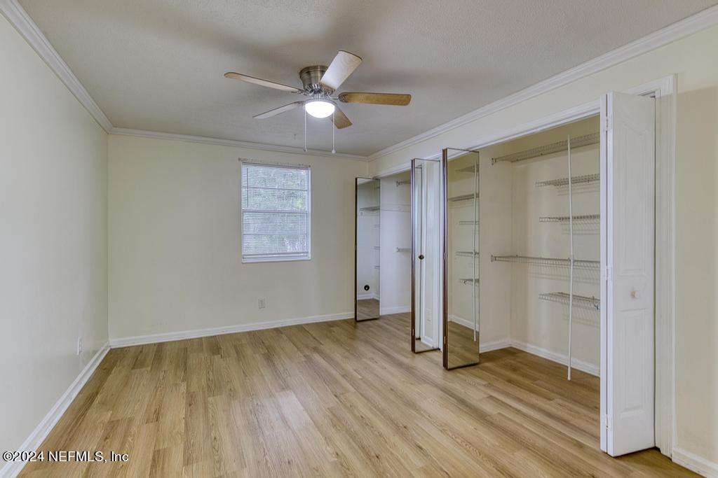 1768 El Camino Road, Unit 7 Jacksonville, FL 32216 - Photo 20 of 43 an empty room with wooden floor closet and windows