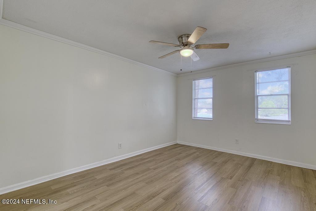 1768 El Camino Road, Unit 7 Jacksonville, FL 32216 - Photo 24 of 43 an empty room with wooden floor fan and windows