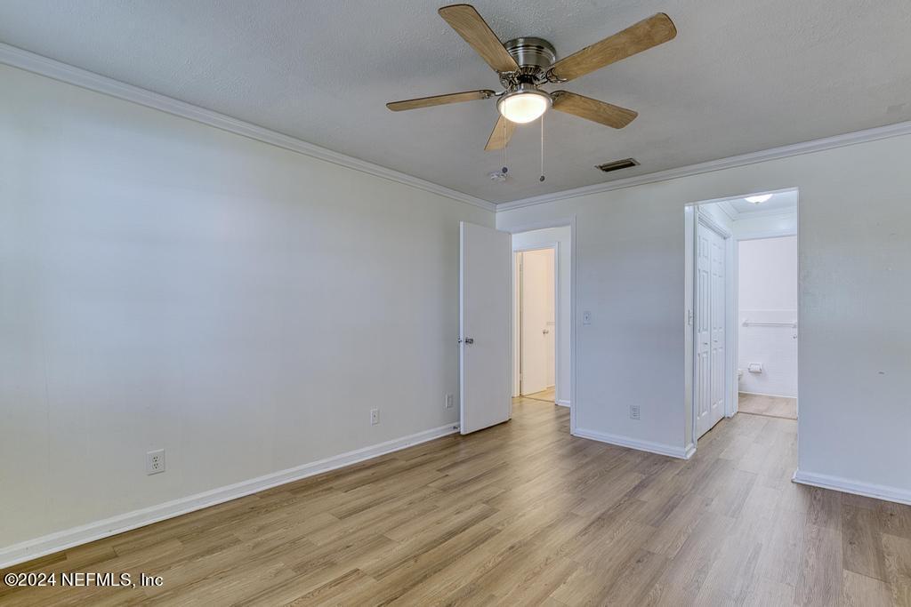 1768 El Camino Road, Unit 7 Jacksonville, FL 32216 - Photo 25 of 43 an empty room with wooden floor and a ceiling fan