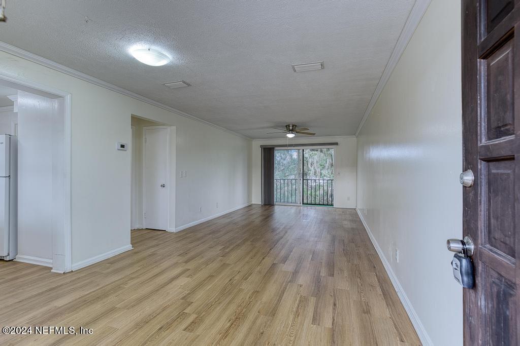1768 El Camino Road, Unit 7 Jacksonville, FL 32216 - Photo 7 of 43 wooden floor in an empty room with a window