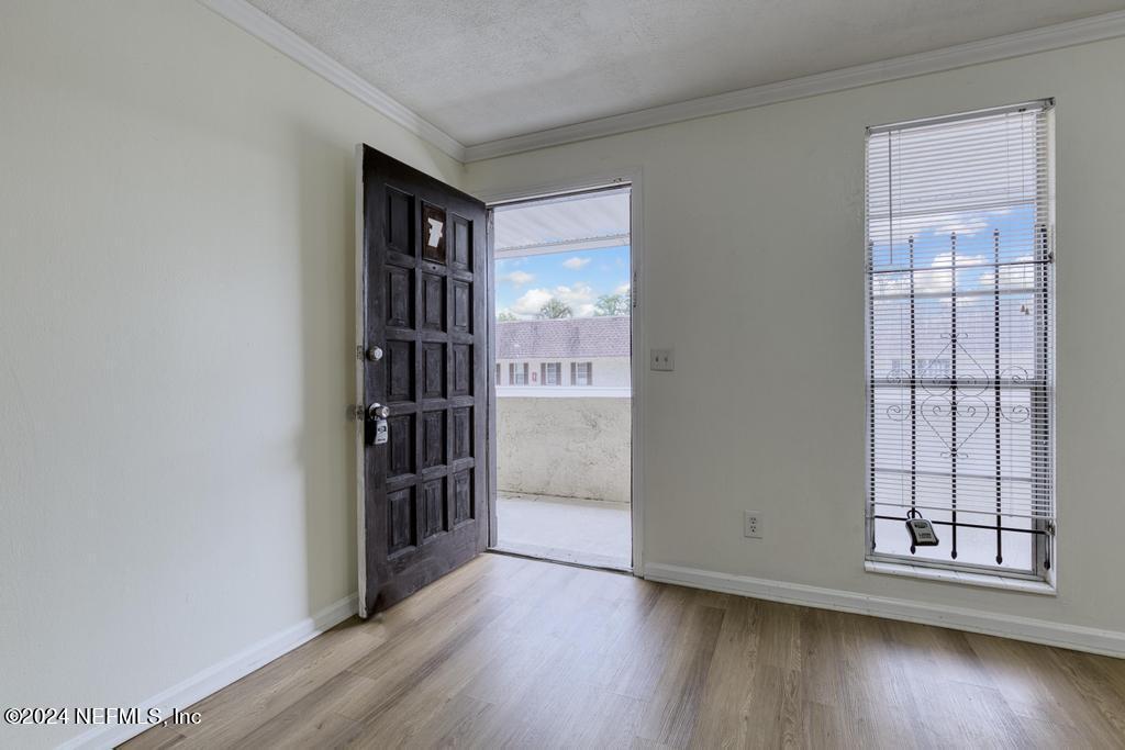 1768 El Camino Road, Unit 7 Jacksonville, FL 32216 - Photo 8 of 43 an empty room with wooden floor and windows