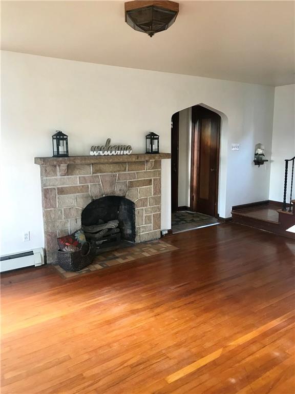 Beautiful hardwood floors, lovely stone fireplace, arched entryway