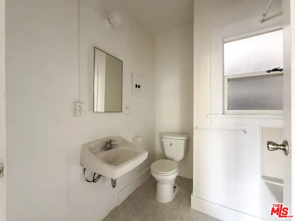 a white toilet sitting next to a bathroom sink