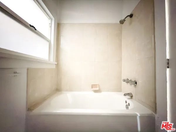 a bathroom with a bathtub and a shower