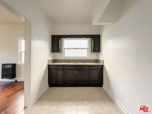 a bathroom with a granite countertop sink and mirror