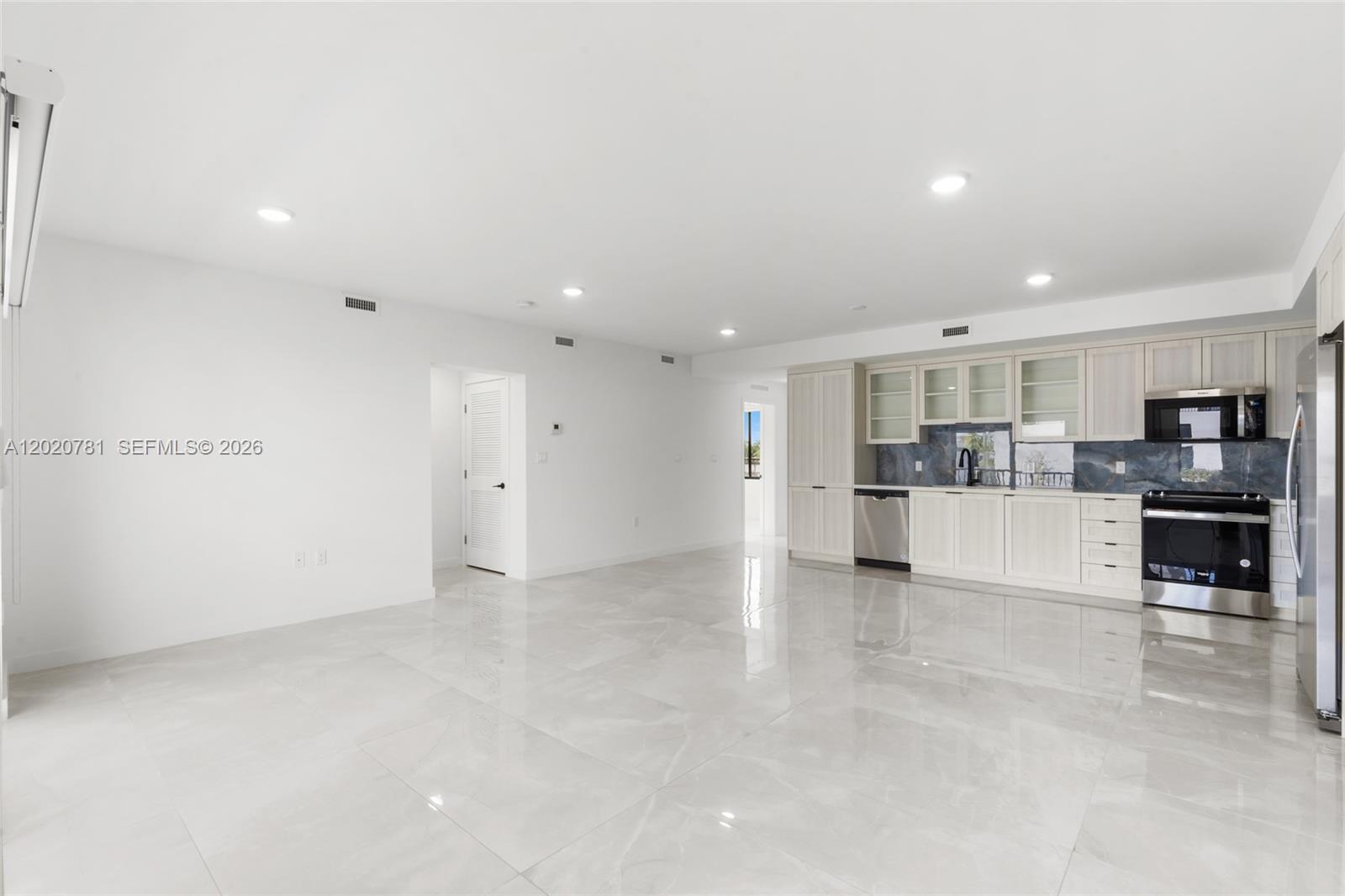 14530 Southwest 261st Terrace, Unit 2 Homestead, FL 33032 - Photo 3 of 23 a view of kitchen with refrigerator and kitchen island