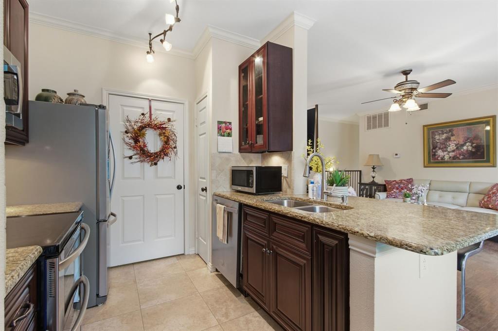 2524 Preston Road, Unit 1607 Plano, TX 75093 - Photo 15 of 28 Kitchen with granite counters, appliances, pantry and door to Laundry Room